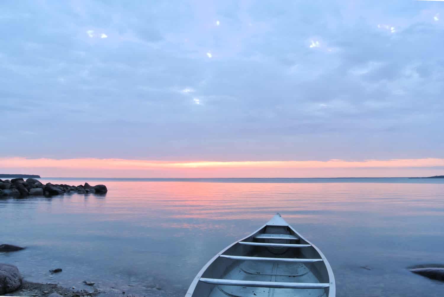 Tip of the canoe pointing out into the water toward the sunset, Hecla Island, Lake Winnipeg, Manitoba