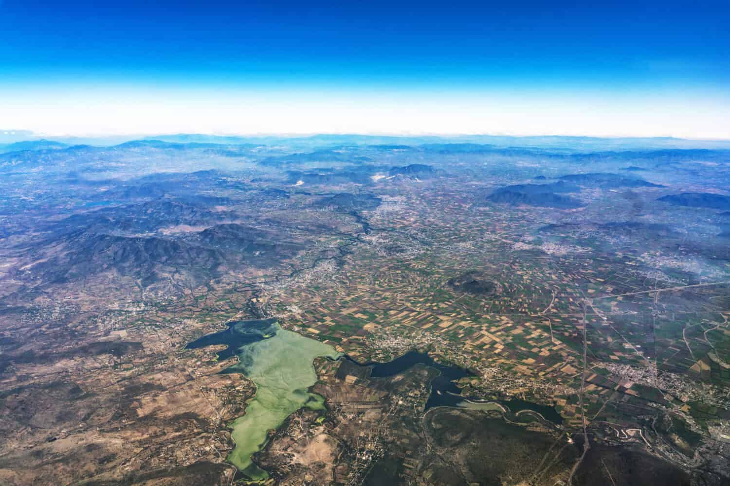 lake texcoco farmed fields and mountains near mexico city aerial view landscape from airplane leon city guadalajara