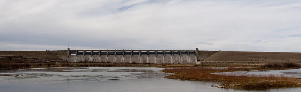 Wide panoramic view of the face of the dam that forms John Martin Reservoir on the Arkansas River near Lamar, Colorado.