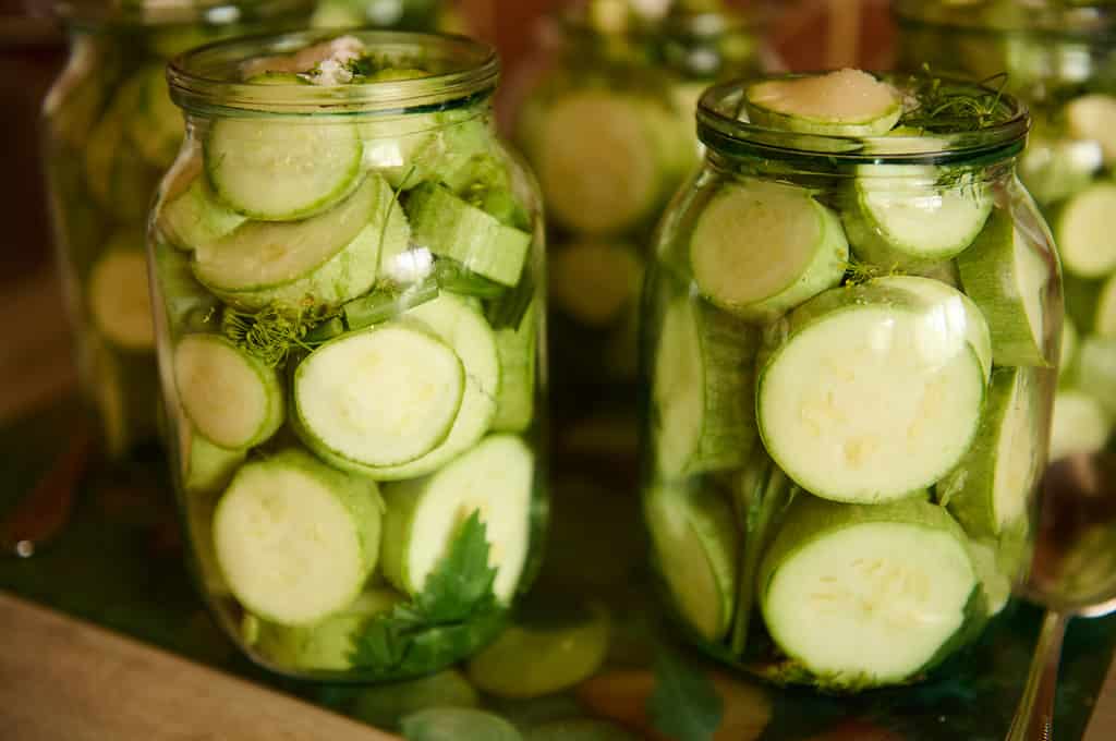Pickling Canning Marinating. Preserving vegetables for the winter. Organic sliced courgettes, zucchini pickled in brine