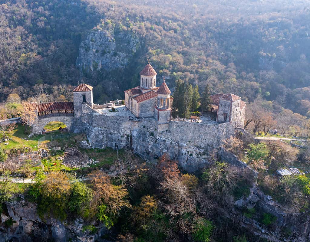 View from drone of Motsameta Monastery complex on rock, Georgia