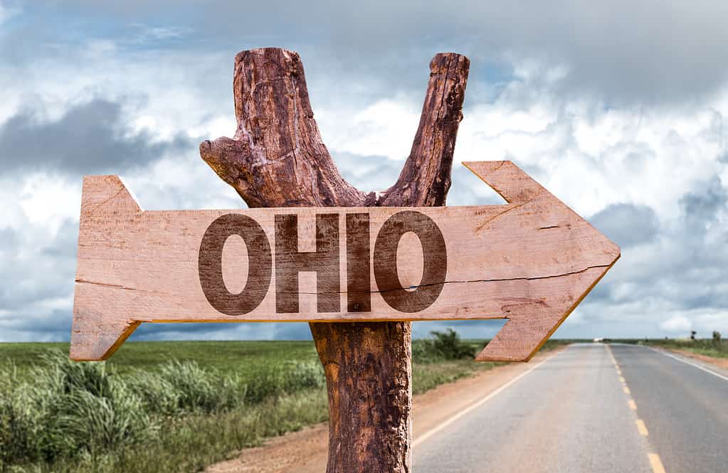 Ohio wooden sign with agriculture landscape on background