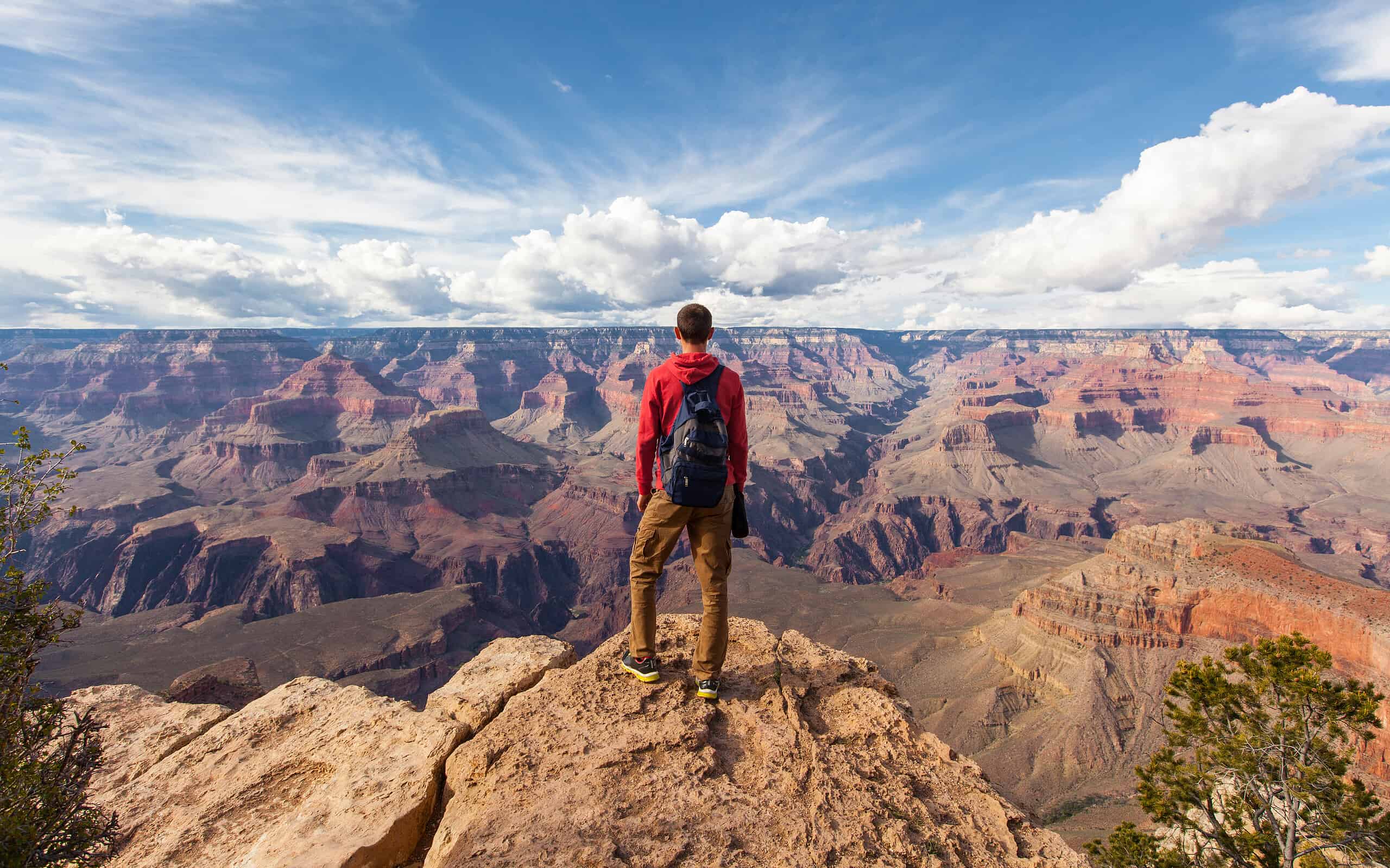 Travel in Grand Canyon, man Hiker with backpack enjoying view