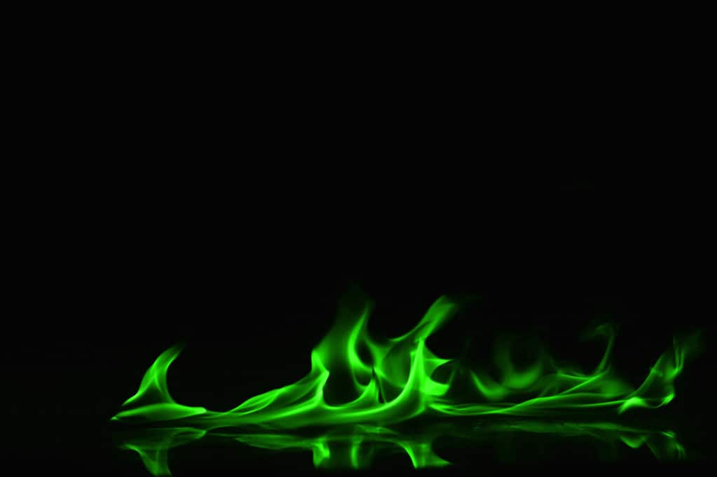 Borax and copper sulfate are common chemicals burned to produce green flames.