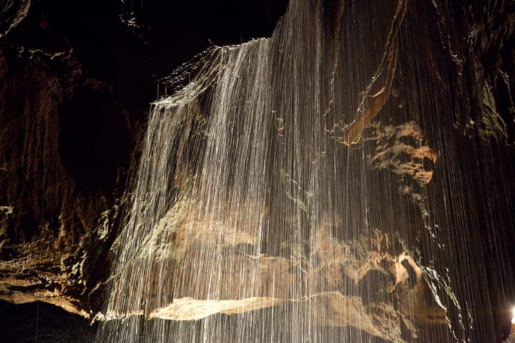 Formations and underground waterfall in Tuckaleechee Caverns in Townsend Tennessee, an abstract study of light and dark