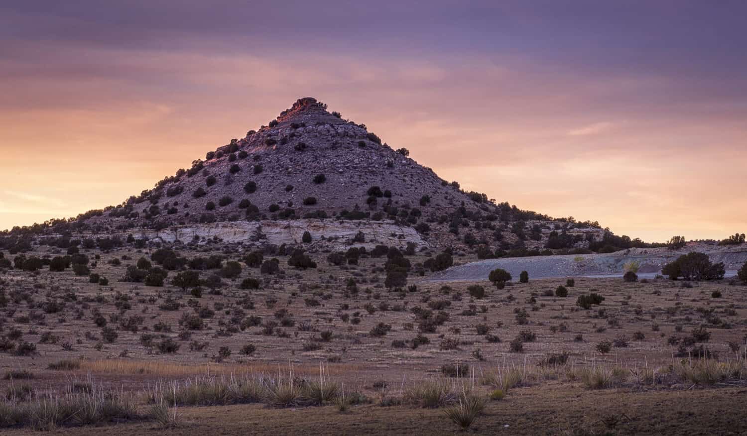 The sun sets on this pointy mountain/hill near Black Mesa in the Oklahoma panhandle.