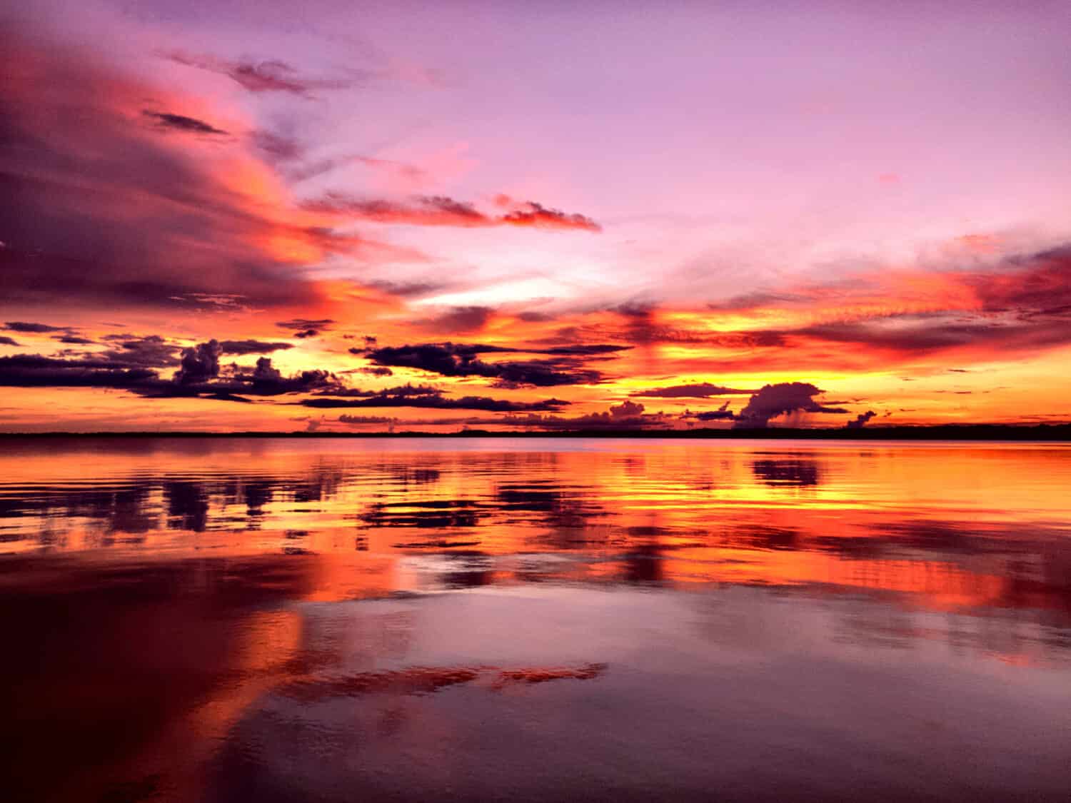 Reflections of the sky and sunset on Lake Eustis Florida.  Orange purple