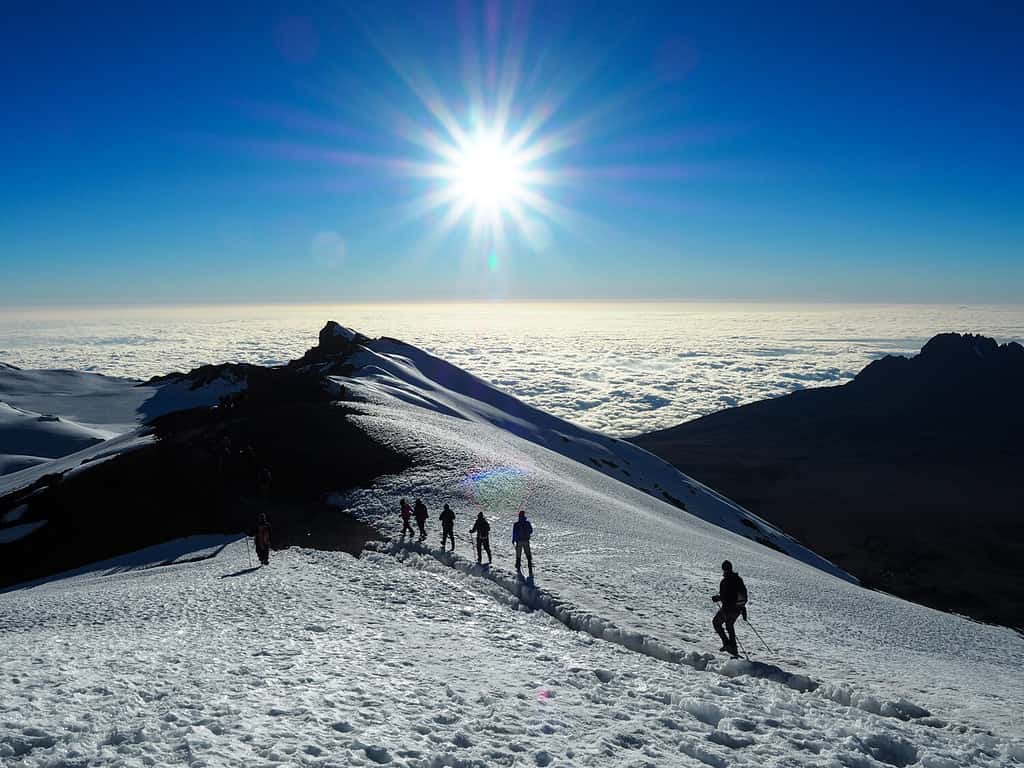 Hikers make their way to the summit of Mount Kilimanjaro on the snow