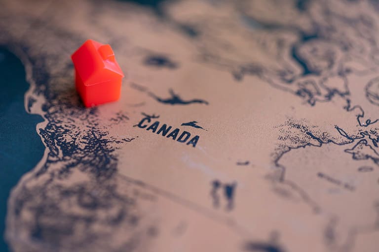House on Canada part of world map. Selective focus. Real estate in Canada concept.