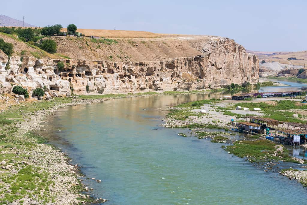 View of the Tigris River valley, caves and various cafes right in the river water under awnings, escaping from the heat in the cool