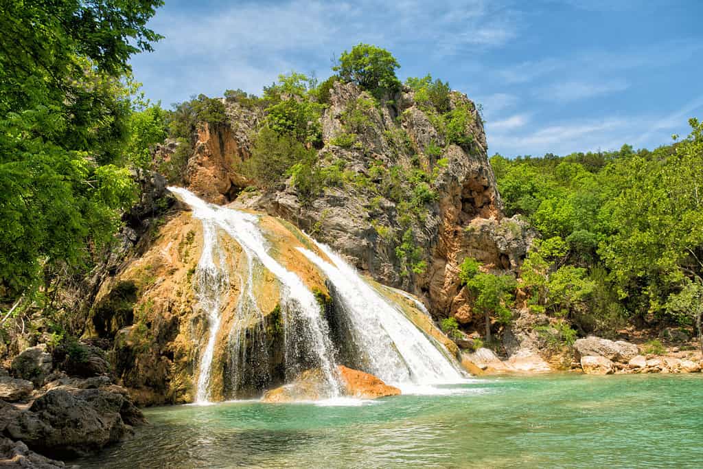 Water cascading over rocks into a natural pool at Turner Falls in Oklahoma in spring