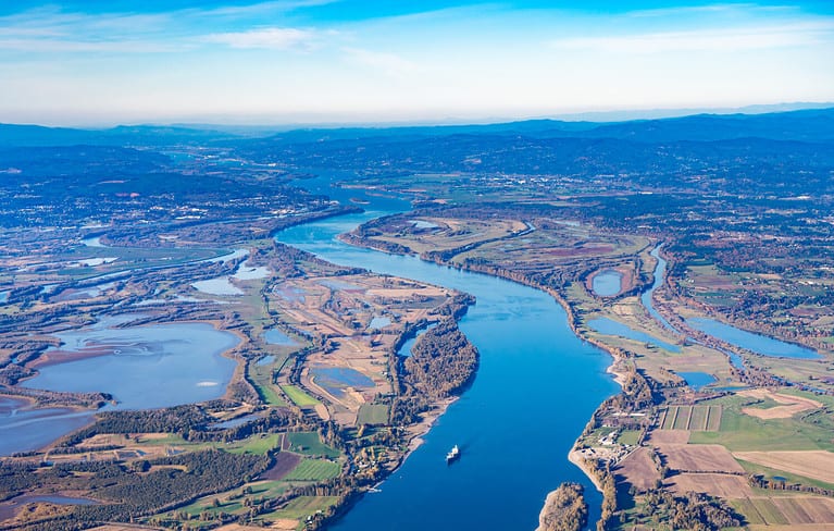 Aerial view of Sauvie island farm and wildlife area and the Columbia River leading west toward Astoria, Oregon, from Vancouver, Washington