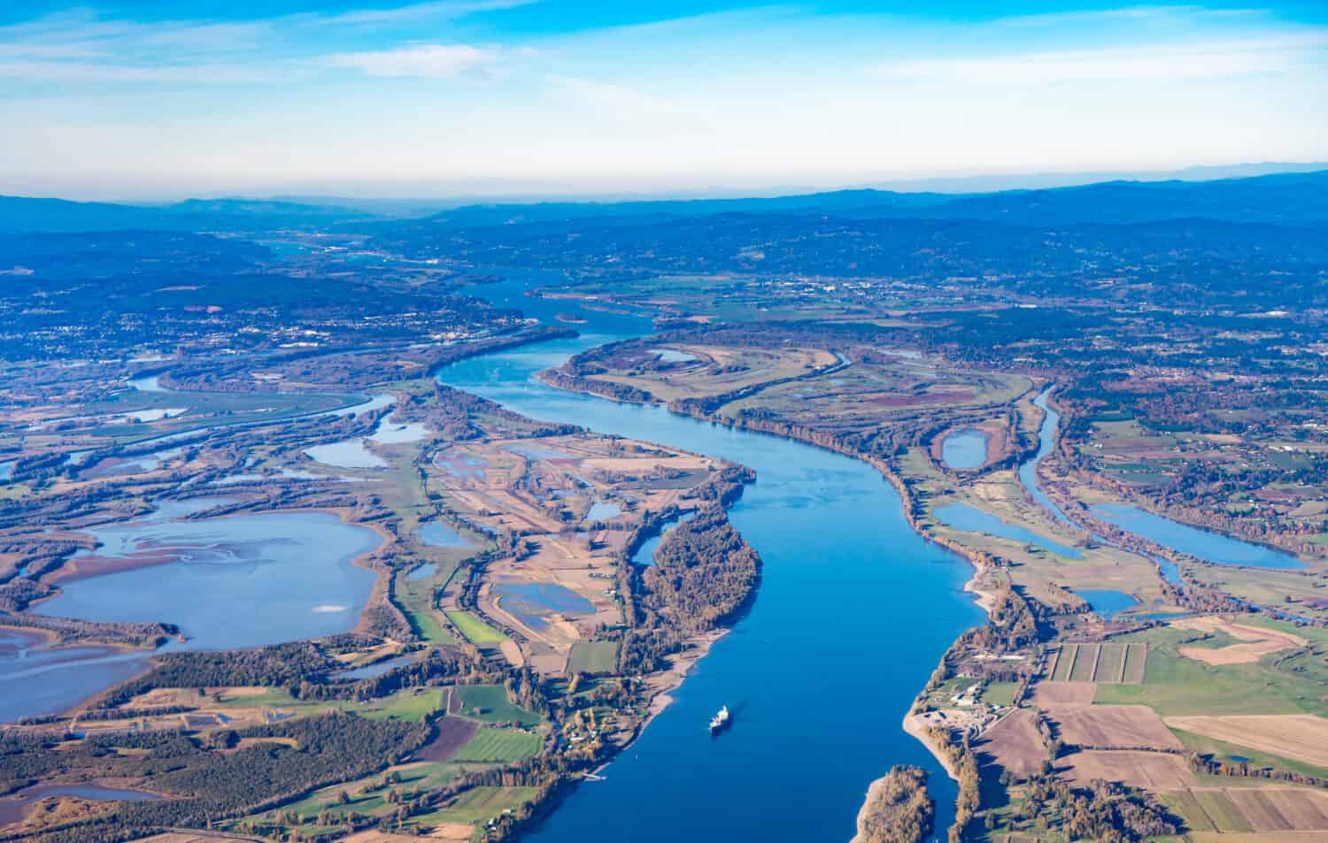 Aerial view of Sauvie island farm and wildlife area and the Columbia River leading west toward Astoria, Oregon,  from Vancouver, Washington