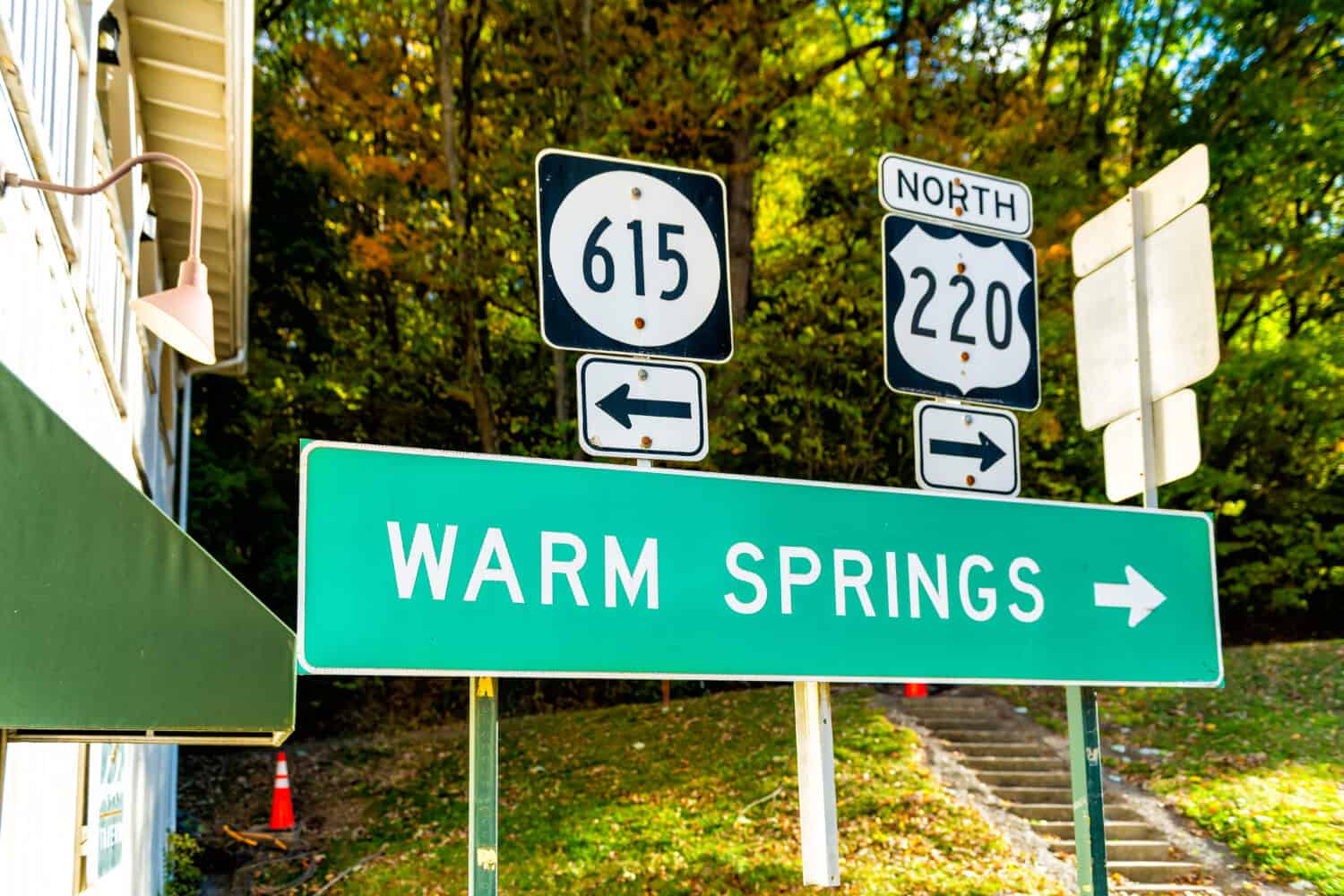 Hot Springs, USA downtown town village city in Virginia countryside with street road highway 615 and 220 directional sign for Warm Springs and arrow