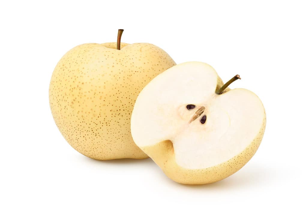 Chinese pear with cut in half isolated on white background. Clipping path.