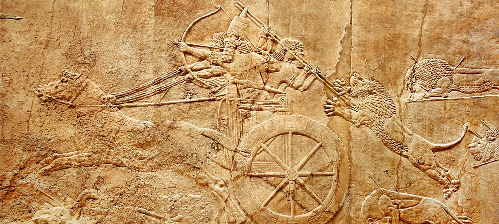 Assyrian wall relief, Ancient carving from Mesopotamia. History of Iraq, civilization of Sumer. Monument of Assyria and Babylon culture. Panorama of lions, king Ashurbanipal, chariot. Heritage theme.