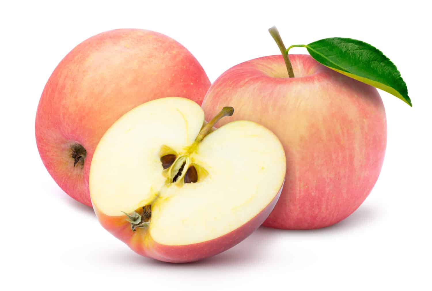 Closeup two fresh red fuji apple with green leaf and cut in half slice isolated on white background. 