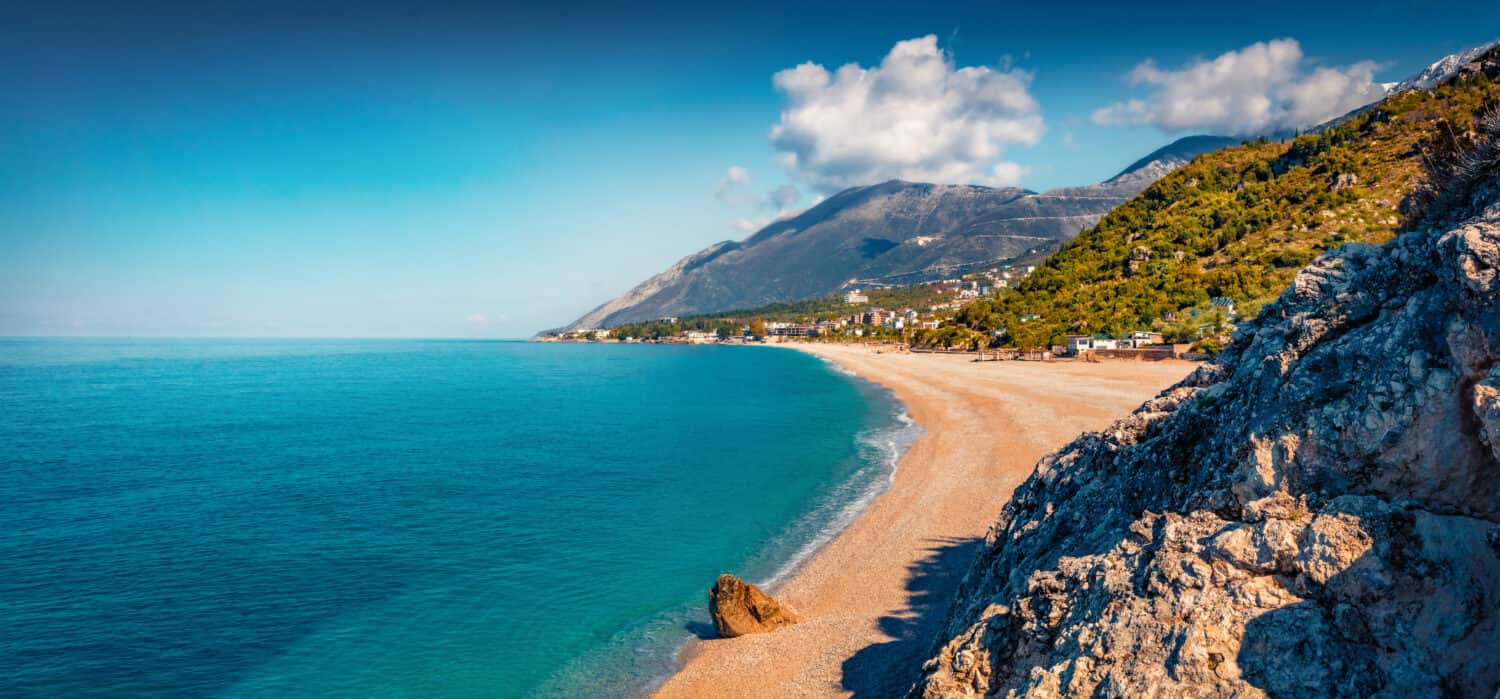 Panoramic spring view of publik beach in Dhermi town. Colorful morning seascape of Adriatic sea. Attractive spring scene of Albania, Europe. Traveling concept background.