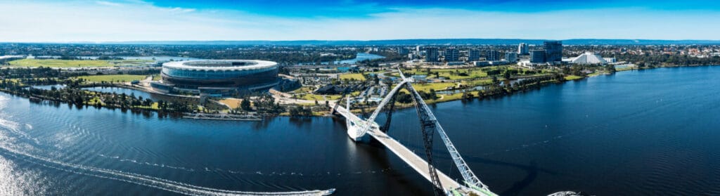 East Perth, Western Australia. Aerial panorama showing Matagarup Bridge pedestrian suspension bridge crossing the Swan River in Perth, and also Perth Stadium.