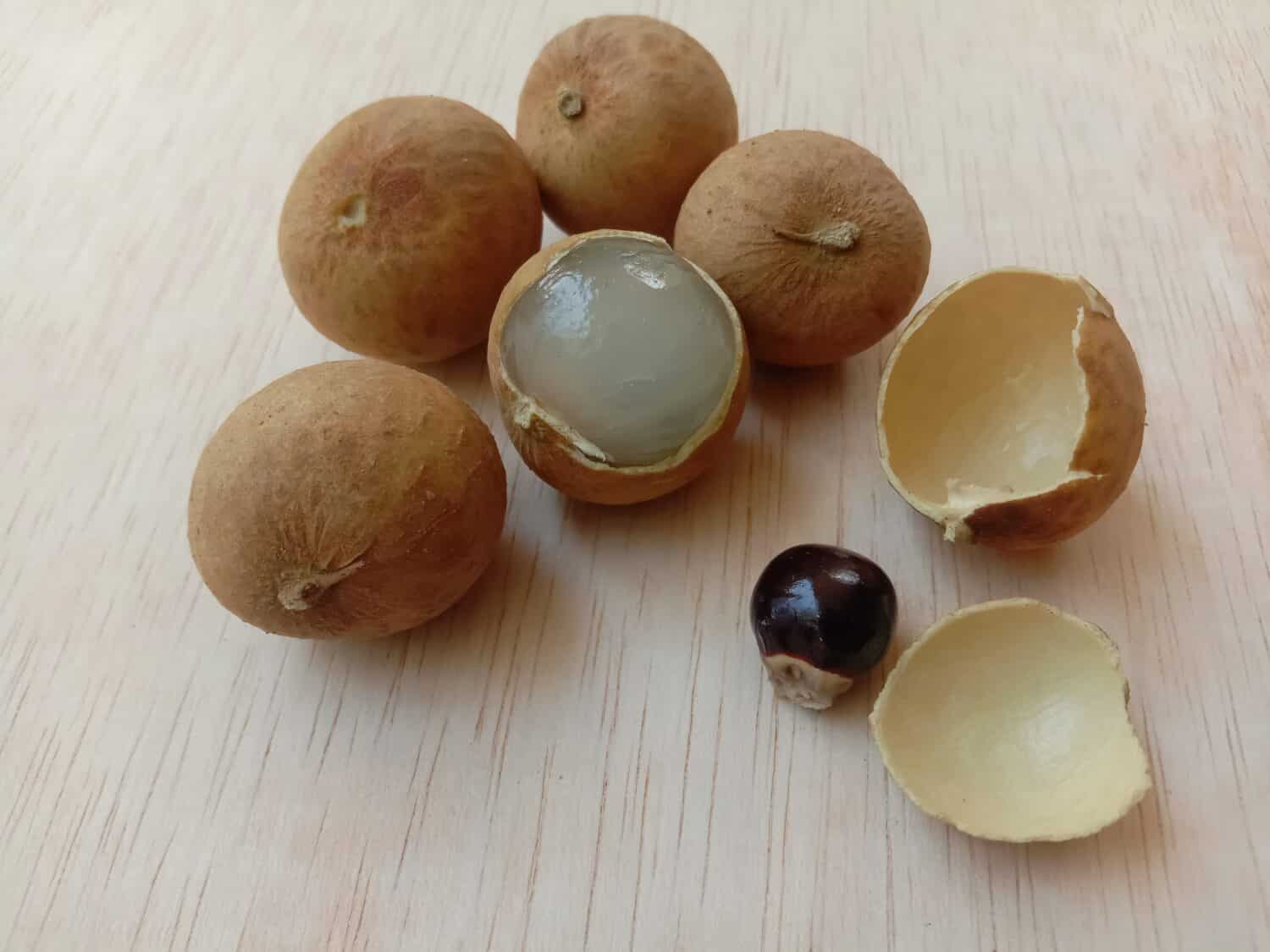 Fresh longan fruit isolated on a plywood background. Selective focus.