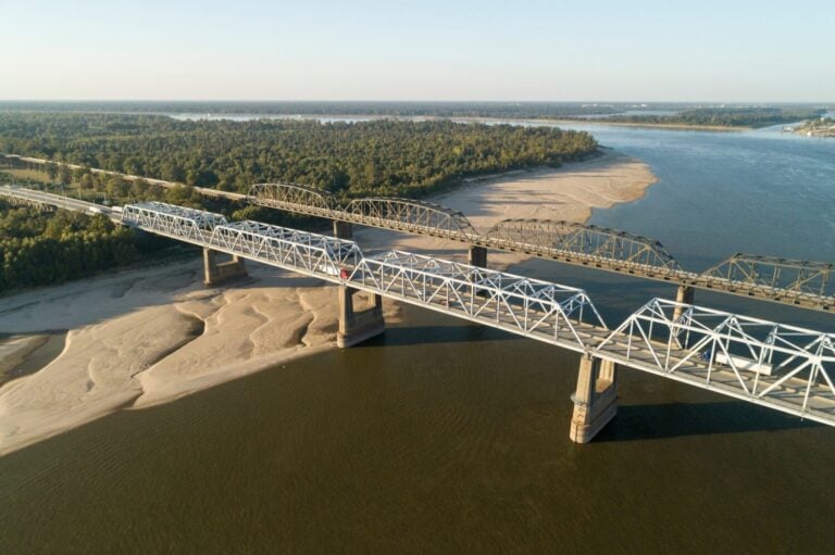 The Interstate 20 and old Highway 80 bridges at Vicksburg, Mississippi, take automobiles and trains over the Mississippi River. Low water reveals the sandbars.