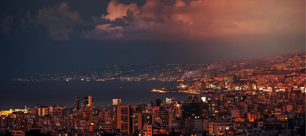 Beautiful Night Landscape of a Coastal City. Houses with Glowing Windows in Evening Light. Gorgeous Mountainous Town. Jounieh. Lebanon.