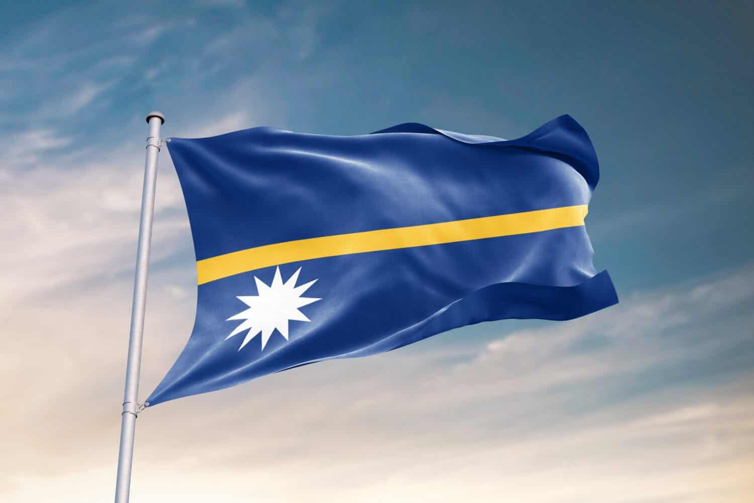 Waving flag of Nauru in beautiful sky. Nauru flag for independence day. The symbol of the state on wavy fabric.