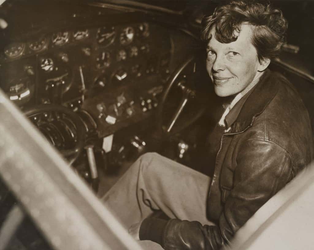 Amelia Earhart sitting in the cockpit of her Lockheed Electra airplane, ca. 1936.