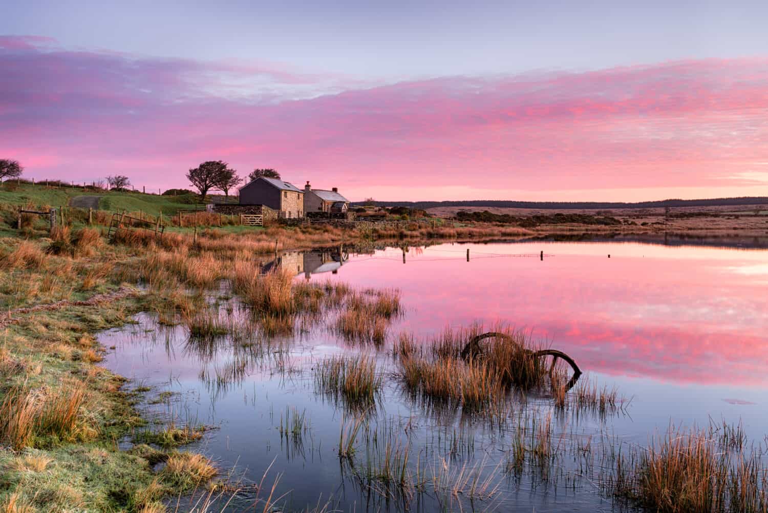Stunning sunrise over Dozmary Pool on Bodmin Moor in Cornwall, a small natural lake steeped in Arthurian legend and reputedly the haunt of the Lady of the Lake