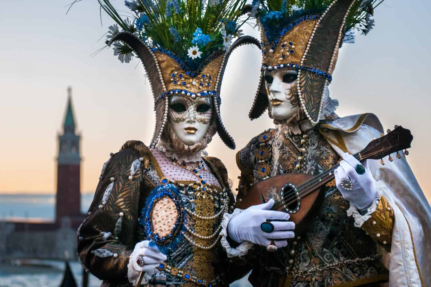 Beautiful couple of masks at St. Mark square during the carnival of Venice.