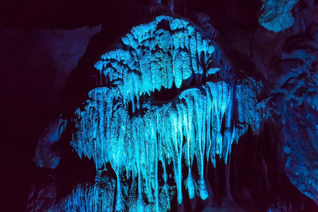 cave blue illuminated flowstones, stalactites and stalagmites