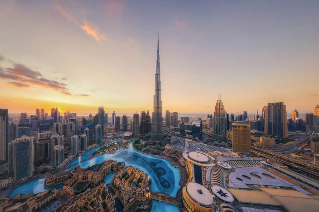 Aerial view of Burj Khalifa in Dubai Downtown skyline and fountain, United Arab Emirates or UAE. Financial district and business area in smart urban city. Skyscraper and high-rise buildings at sunset.