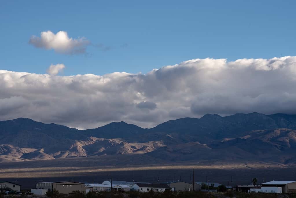 Mojave desert valley, mountain range, cloudy skies