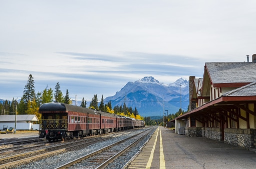 Train of old type staying at Banff Station with autumn leaves and Cascade Mountain in Autumn, Banff National Park, Canadian Rockies, Alberta, Canada