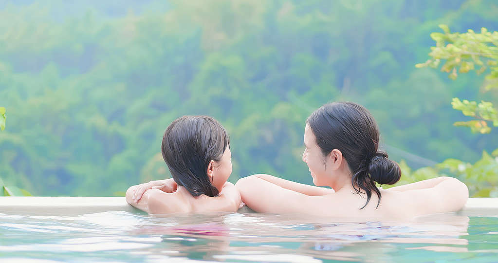 asian family enjoy hot spring