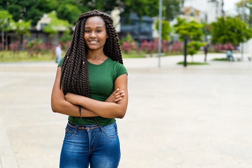 Woman with green shirt and crossed arms