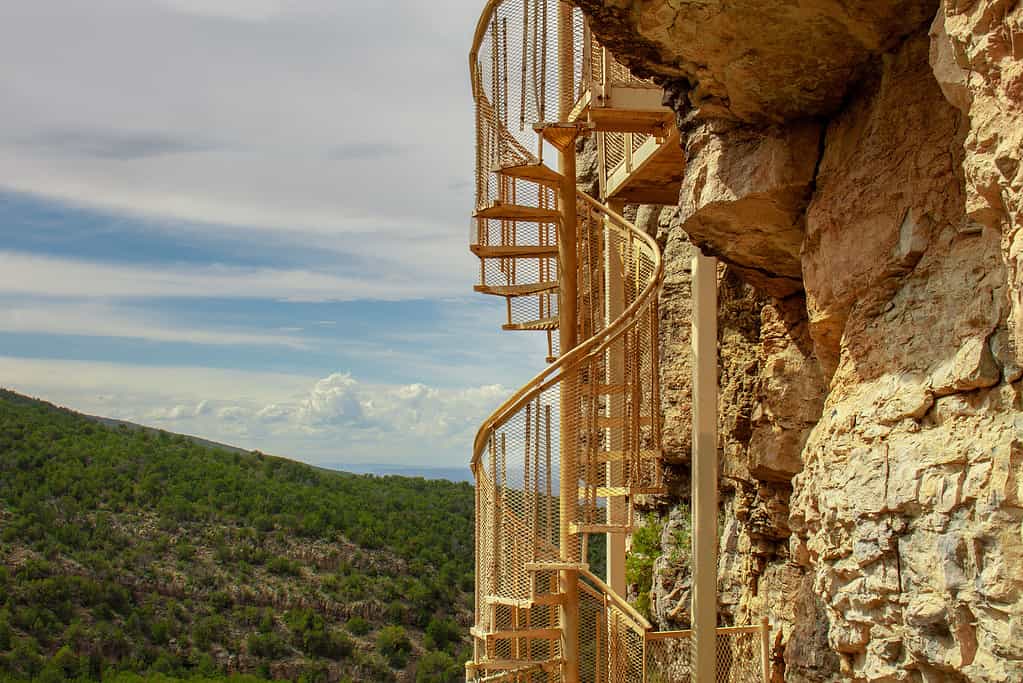View of cliff-side trail and spiral staircase going up to the Sandia Man Cave in the Sandia Mountains outside Placitas, New Mexico