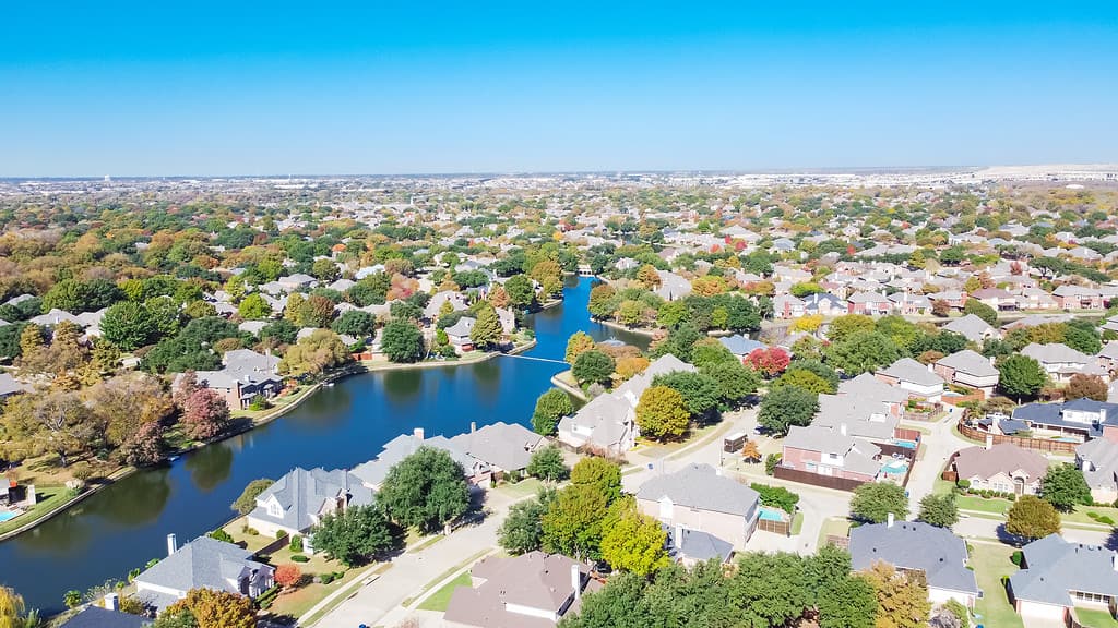 Aerial view upscale lakeside houses surrounded by beautiful autumn leaves in Coppell, Texas, USA