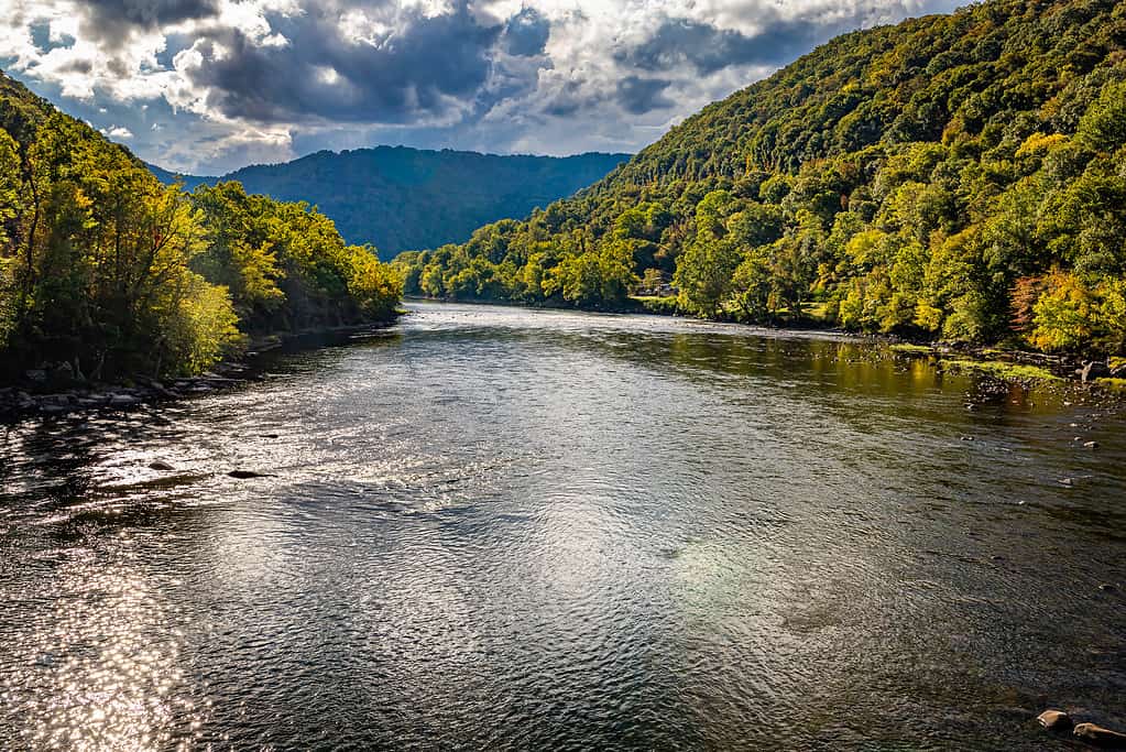 The New River passes by Prince West Virginia near the New River Gorge National Park and Preserve during the Autumn leaf color change.