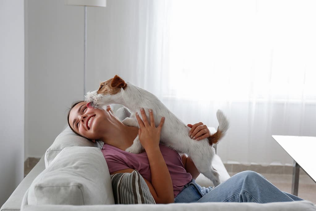 Woman chilling with her dog at home.