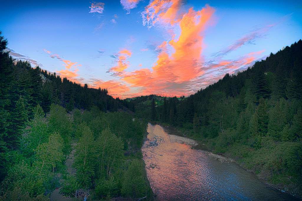 A beautiful pink and orange sunset on the Dear Born river during June in Augusta, Montana