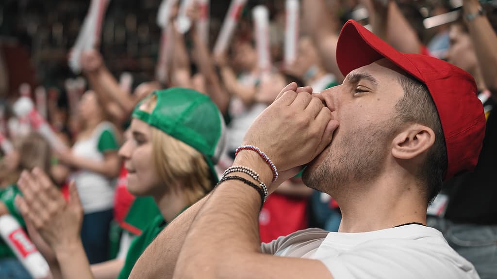 Hockey couple betting fan sport stands arena. Score goal joy. People watch game.