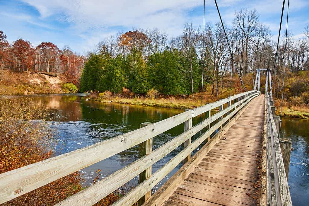 Manistee River Trail suspension bridge in late fall over river.jpg