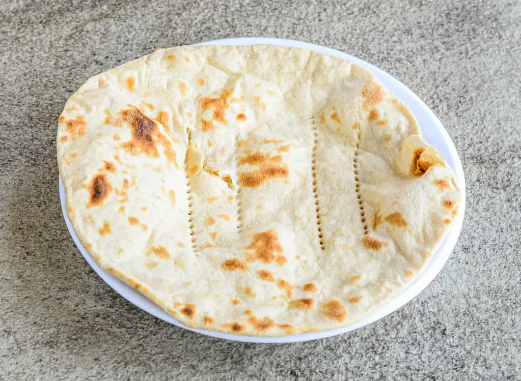 Tandoori roti, rumali, tawa chappati and pita bread served in plate isolated on grey background top view of pakistani and indian spices food