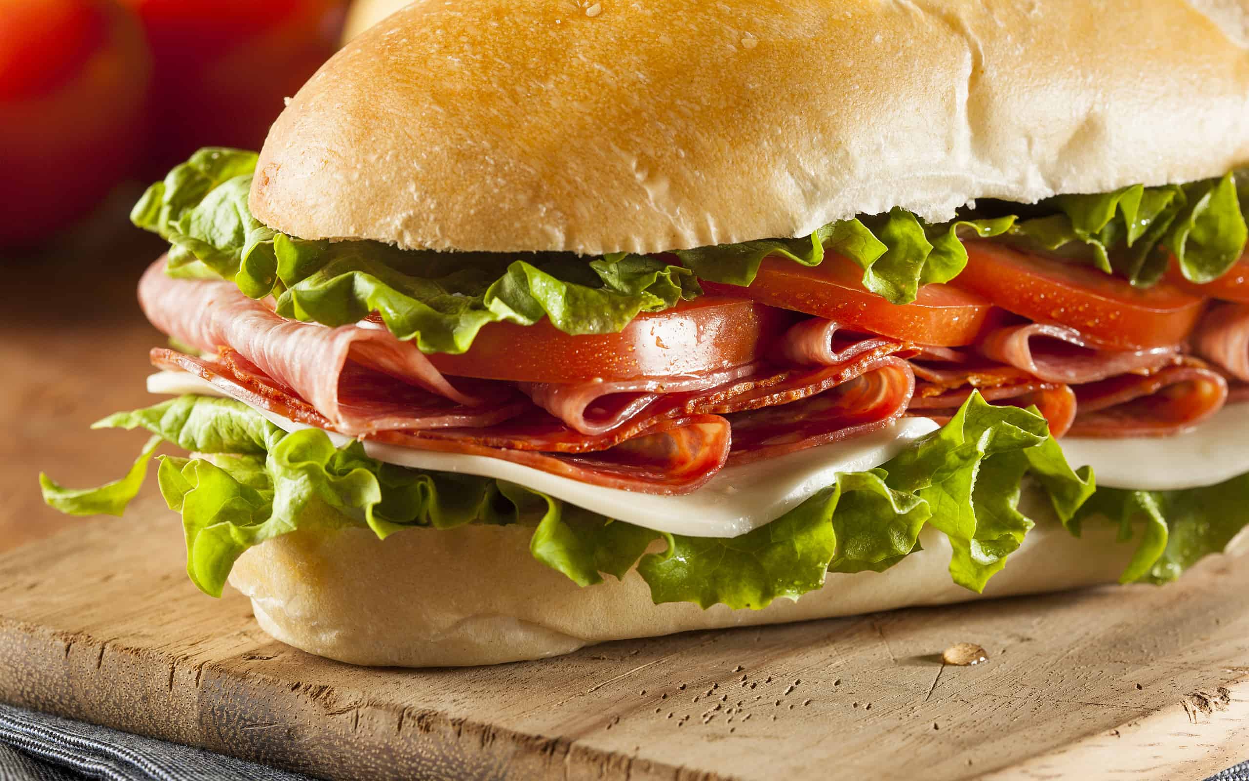 Close-up Italian sub hoagie sandwich cutting board stuffed