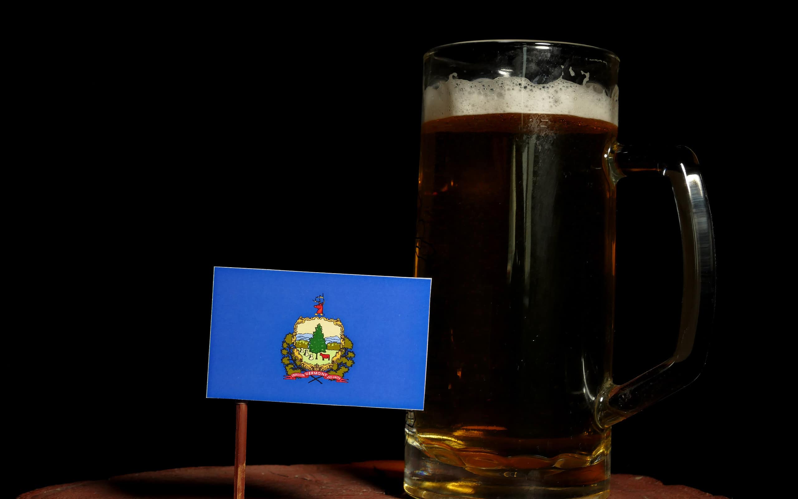 Vermont flag with beer mug isolated on black background