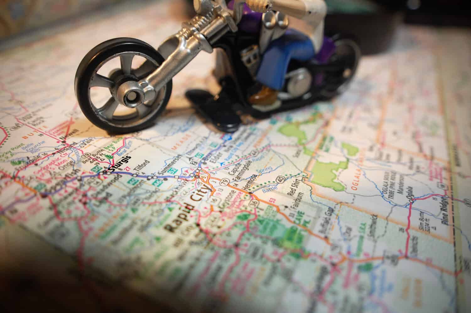 A toy motorcycle pictured with a map of Sturgis, South Dakota.