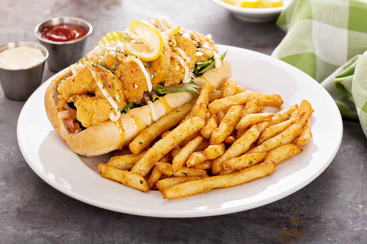 Shrimp po boy sandwich with fries served with soda