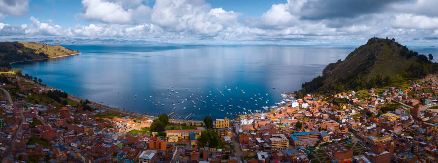 Aerial panorama of the lake of Titicaca and the town of Copacobana during the sunny calm day, Bolivia