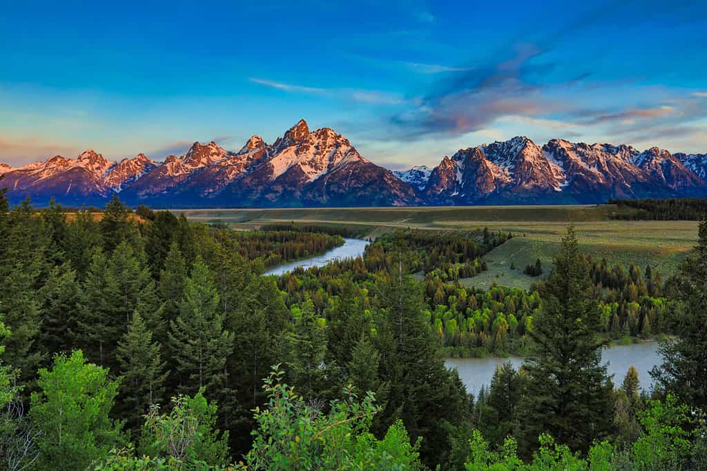 Sunrise from the Snake River Overlook in Wyoming with the Grand Tetons in the background.
